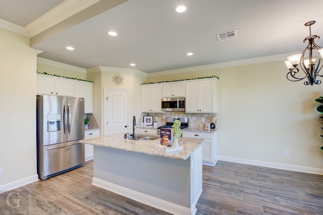 kitchen with hardwood / wood-style flooring, sink, stainless steel appliances, and white cabinets