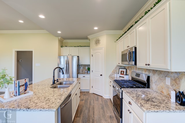 kitchen featuring stainless steel appliances, dark wood-type flooring, a kitchen island with sink, and white cabinetry