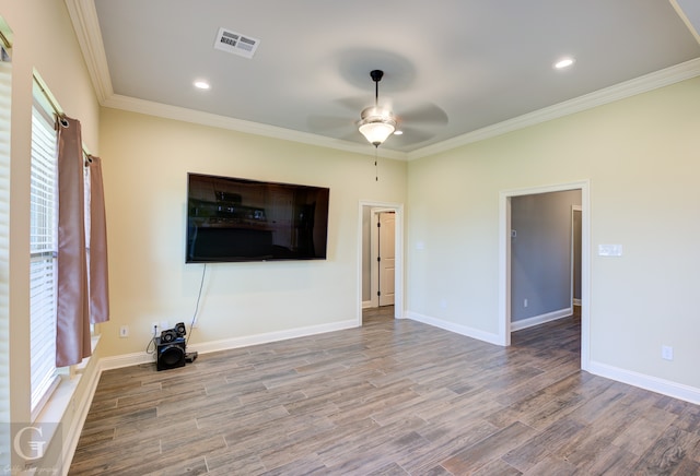 unfurnished living room featuring ornamental molding, ceiling fan, and wood-type flooring