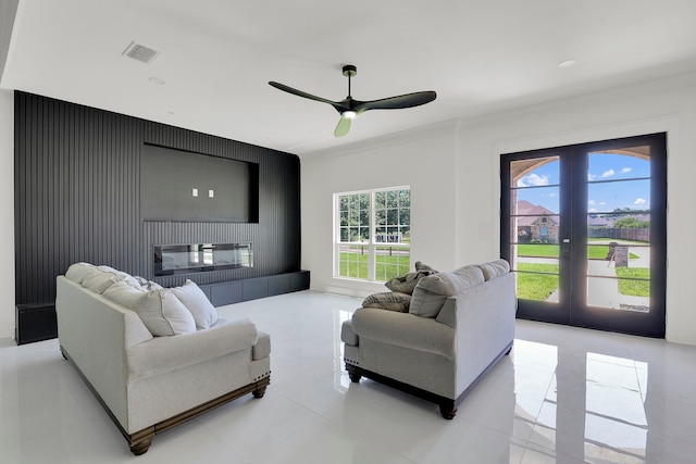 tiled living room featuring ceiling fan, plenty of natural light, and french doors