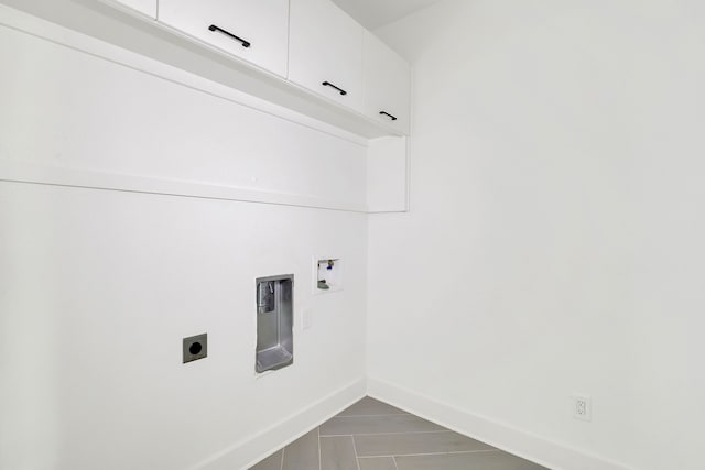 clothes washing area with cabinets, hookup for an electric dryer, and hookup for a washing machine