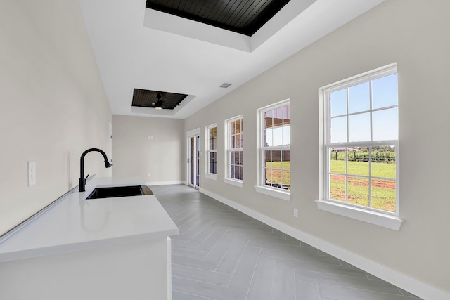 interior space featuring ceiling fan and sink