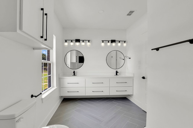 bathroom featuring vanity and toilet