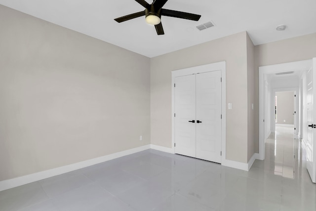 unfurnished bedroom with light tile patterned flooring, ceiling fan, and a closet