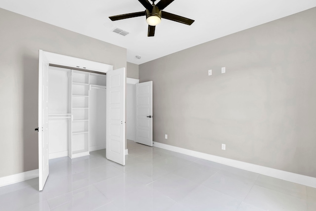 unfurnished bedroom with ceiling fan, a closet, and light tile patterned floors