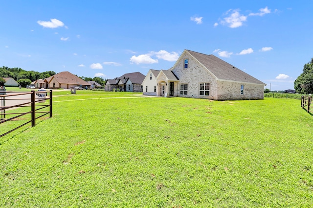 rear view of house with a yard