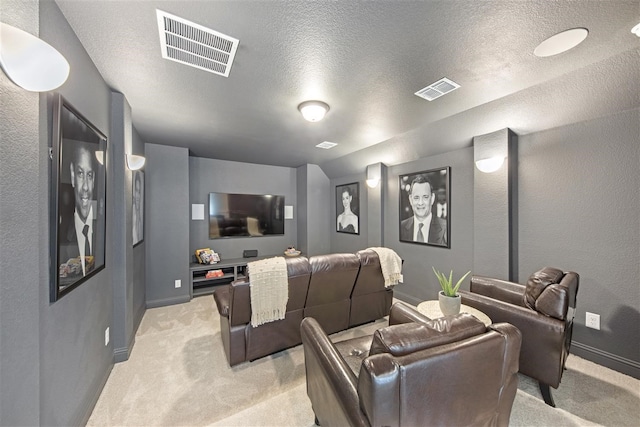 home theater with a textured ceiling and light colored carpet