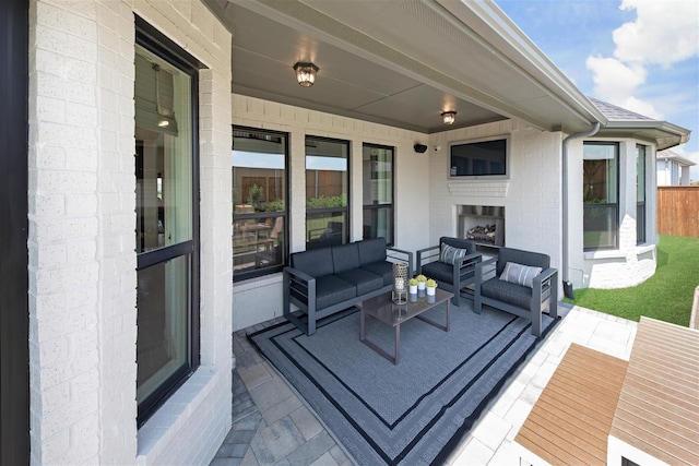 wooden deck with an outdoor living space with a fireplace and a patio area