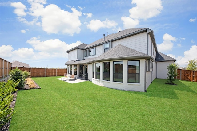 back of property with a lawn and a patio area