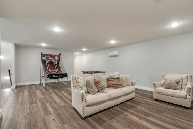 living room featuring hardwood / wood-style floors and an AC wall unit