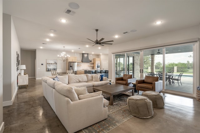 living room with concrete flooring and ceiling fan with notable chandelier