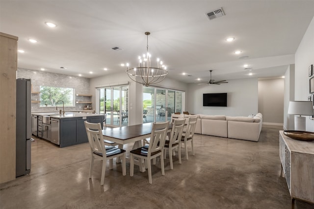 dining space with ceiling fan with notable chandelier