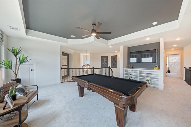 game room featuring light carpet, a tray ceiling, billiards, and ceiling fan