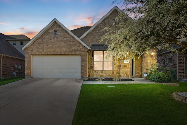 view of front facade with a lawn and a garage