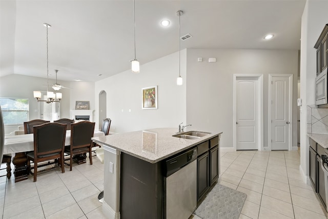 kitchen with an island with sink, decorative light fixtures, sink, and stainless steel dishwasher