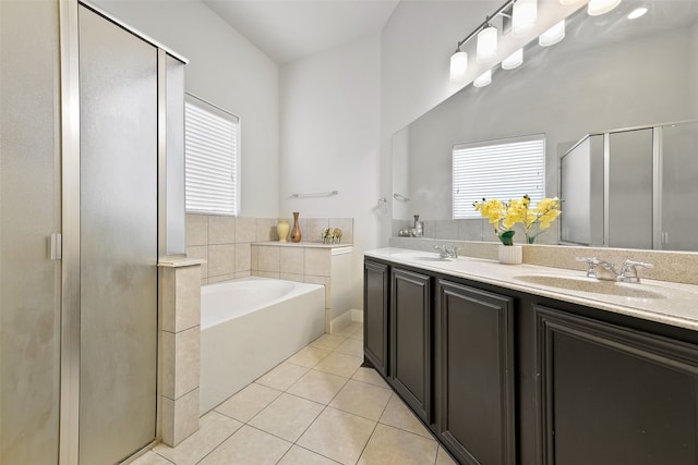 bathroom featuring tile patterned floors, vanity, and plus walk in shower