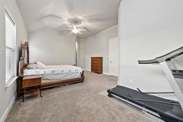 carpeted bedroom with vaulted ceiling, multiple windows, and ceiling fan