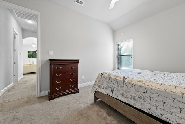 bedroom featuring lofted ceiling, light colored carpet, and ceiling fan