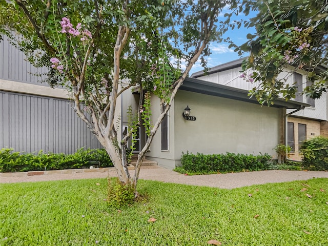 view of side of property with a lawn