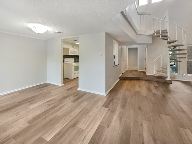 interior space featuring a textured ceiling and light wood-type flooring