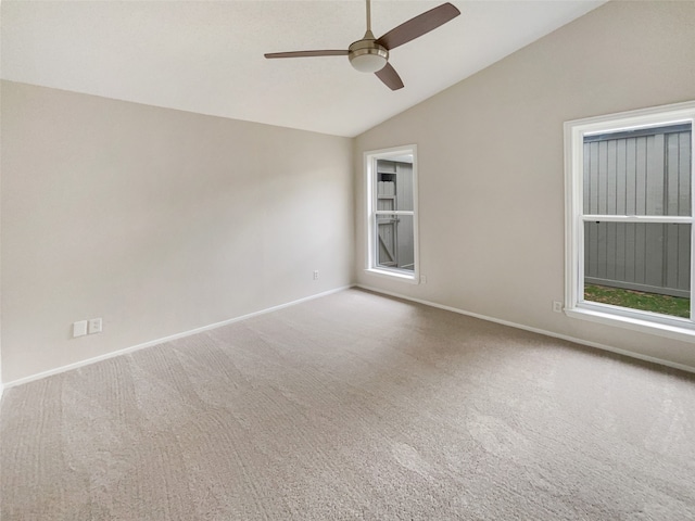 carpeted spare room featuring ceiling fan and lofted ceiling