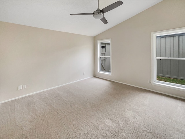 spare room with carpet flooring, vaulted ceiling, and ceiling fan