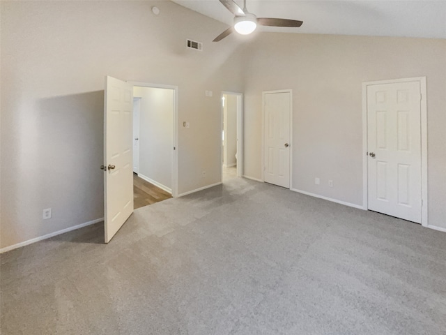 carpeted empty room featuring lofted ceiling and ceiling fan