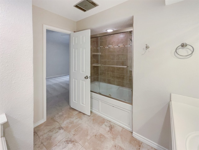 bathroom with bath / shower combo with glass door and vanity