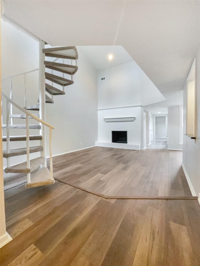 313 Oak Shadow Cir, Bedford, TX 76021 - unfurnished living room with stairs, wood finished floors, visible vents, and baseboards
