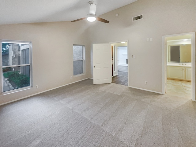 interior space featuring carpet floors, ceiling fan, and high vaulted ceiling