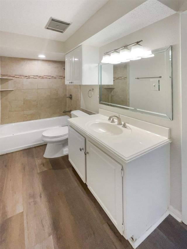 313 Oak Shadow Cir, Bedford, TX 76021 - bathroom featuring wood finished floors, visible vents, shower / bath combination, toilet, and vanity