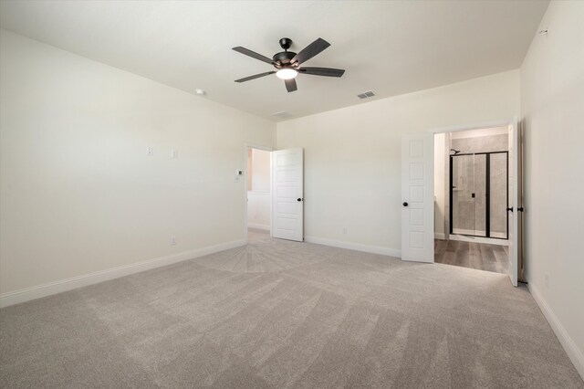 unfurnished room with ceiling fan and light carpet