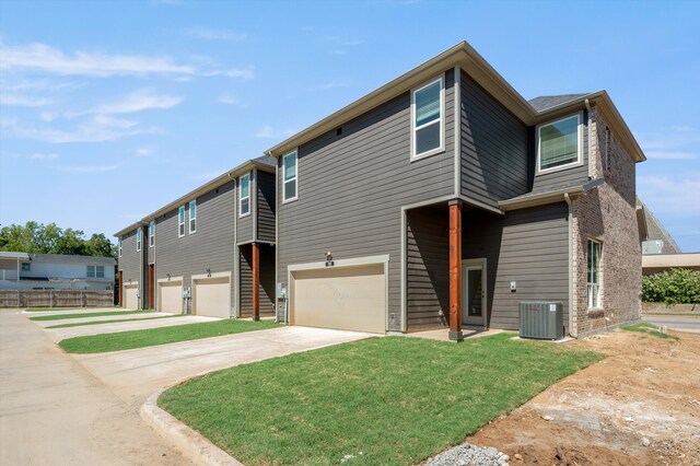 view of front of house featuring a garage and central air condition unit