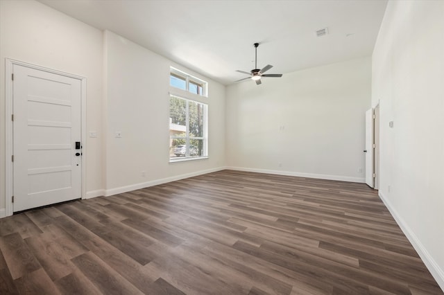 spare room with dark hardwood / wood-style floors and ceiling fan