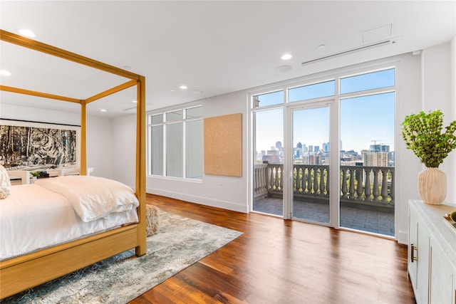 bedroom with wood-type flooring and access to outside