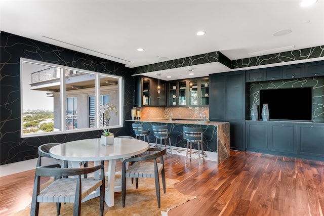 dining area featuring dark hardwood / wood-style flooring and indoor bar