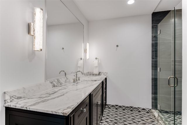 bathroom featuring vanity and a shower with shower door