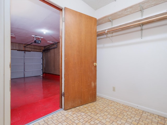 garage with a garage door opener and baseboards