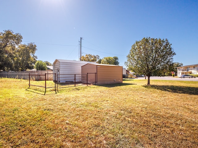 view of yard featuring an outbuilding and fence