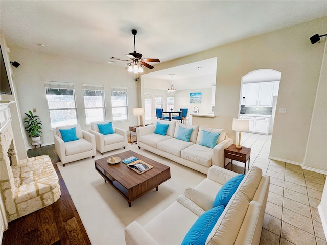 living room featuring ceiling fan and light tile patterned floors