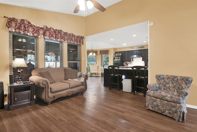 living room featuring ceiling fan and dark wood-type flooring