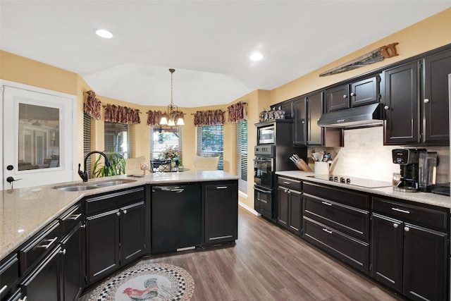 kitchen with hardwood / wood-style flooring, sink, hanging light fixtures, an inviting chandelier, and black appliances