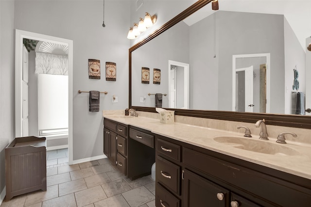 bathroom featuring a high ceiling and vanity