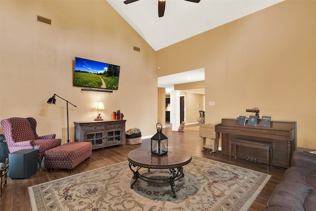 living room featuring ceiling fan, ornate columns, hardwood / wood-style floors, and high vaulted ceiling