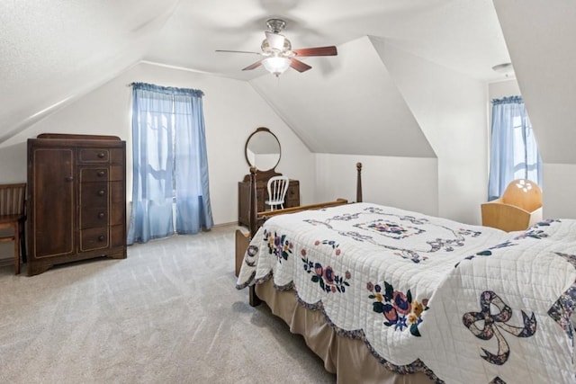 carpeted bedroom with ceiling fan and vaulted ceiling