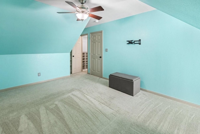 bonus room with light colored carpet, vaulted ceiling, and ceiling fan