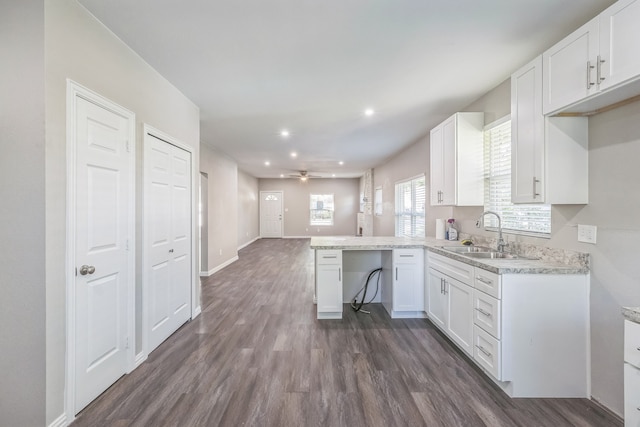 kitchen with plenty of natural light, sink, white cabinets, and ceiling fan