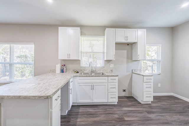 kitchen featuring dark hardwood / wood-style floors, white cabinetry, built in desk, and ceiling fan