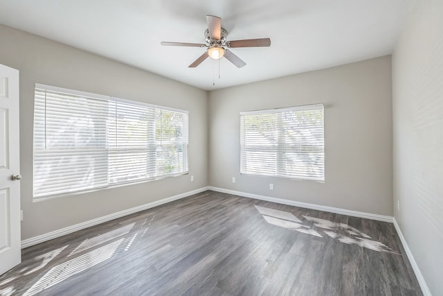 unfurnished room with dark hardwood / wood-style floors and ceiling fan