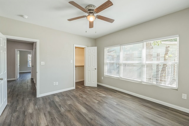 unfurnished room with ceiling fan and dark hardwood / wood-style flooring